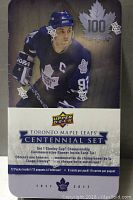 Front of sealed tin showing a Toronto Maple Leafs player in uniform with '100' maple leaf logo and Upper Deck branding.