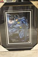 Framed Batman print with dark mat and protective corner covers.