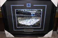Full view of the framed photo with signatures visible, showing black frame and black matting with blue and white accents, Toronto Maple Leafs logo on mat and plaque identifying the team and year.