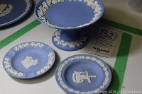 Photo of blue jasperware candy stand and two small plates with white classical relief designs.