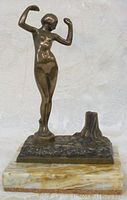 Front view of bronze nude sculpture on marble base.