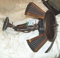 Side angled view showing the metal construction, fan-like design elements, and overall shape.