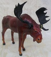 Front and side view of the hand crafted genuine leather moose figurine showing shape and coloring.