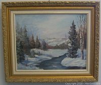Framed oil painting showing full winter landscape scene with snowy trees and river under a cloudy sky.