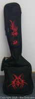 Black soft carrying case with red tribal flame design on front pocket and neck section