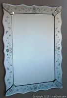 Front view of rectangular mirror with scalloped etched glass border showing detailed floral etching on beveled edge.