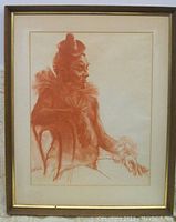 Full view of framed clown watercolor painting showing seated profile with red hues and signature.