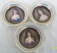 Three Dresden Schumann Bavaria pierced wall plates featuring female portraits with wire hangers visible at the back.