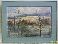 Full view of the framed watercolour landscape painting showing the composition with trees and a soft colorful horizon.
