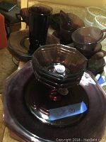 Moroccan amethyst glass cups, plates, and small bowls in deep purple with octagonal edges