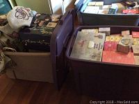 Two large storage bins filled with boxed Precious Moments collectibles including monthly figurine boxes and binder.
