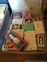 Plastic storage bin filled with stacked original boxes of Precious Moments figurines and ornaments.