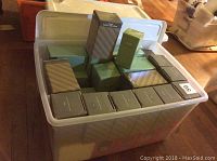 Bin of many Avon boxes containing porcelain and lead crystal birthday bells.