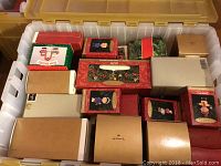 Plastic bin containing multiple Hallmark Keepsake Ornament boxes