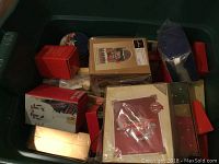 Plastic bin filled with assorted red and green Hallmark Keepsake Ornament boxes