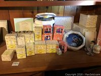 Overall lot showing approximately 30 Precious Moments figurines and boxes displayed on a wooden surface, with pastel and orange colored boxes labeled Precious Moments and Enesco.