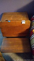 Side view of the vintage wooden school desk showing the attached bench and wood grain finish.
