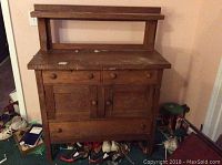 Front view of the vintage wooden cabinet showing entire unit with drawers and storage doors.