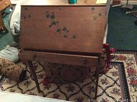 Front view of antique wooden secretary desk showing floral paint design and overall condition including wear and nicks.