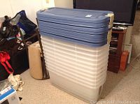 Front view of stacked 11 translucent bases with blue lids