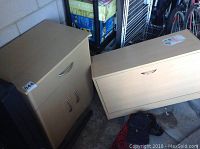 Two small cabinets placed next to each other, showing their size and condition in a garage setting.