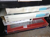 Stacked boxes of kitchen items for storage, showing some wear