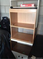 Wooden shelf 24x15.5x33 inches with two open shelves and white front panel