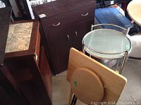 Overview shows five furniture items grouped together: brown wooden cabinet, marble top cabinet, round glass table on metal frame, small wooden table, and wooden stool.
