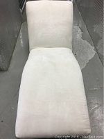 Front and top view of off white Mitchell Gold Cigarette chair upholstery with some stains visible.