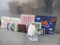 Full view of all wall art pieces and the oval mirror on the floor showing different framed prints and canvases in various sizes and colors.