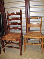 Two rush seat chairs side by side in storage unit, showing dark wood ladder back chair and light wood chair with damage