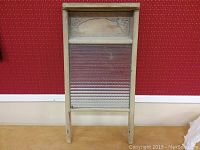 Full view of the vintage washboard showing wooden frame and metal scrubbing panel.