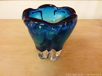 Front angled view of the blue and clear art glass vase showcasing its ruffled top and organic shape.