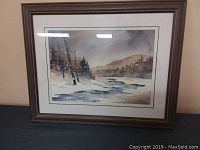 Framed original watercolor painting by Sherry Pringle depicting a snowy landscape with trees and river.
