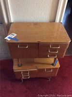 Two stacked mid century modern style wooden end tables showing tops and drawer fronts with wear and scratches. View angled from above and side.
