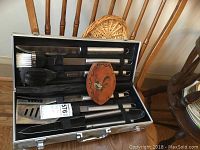 BBQ tool set in metal carrying case seen open with utensils