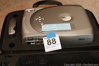 Dell 2100MP projector inside the molded soft case with handle, showing ports and taped note with usage instructions