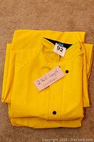Yellow rain slicker folded with note indicating '2 full length slickers'