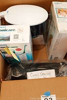 Boxed Philips Sonicare AirFloss, Conair Pro Style Mini 1500 hair dryer, and Curl Genius in cardboard box.