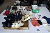 Photo of all shoes and accessories including athletic shoes, loafers, espadrilles, socks, and foot care insoles arranged on a table