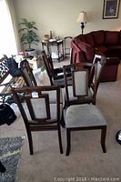 Four chairs arranged in two rows showing front and back upholstery panels.