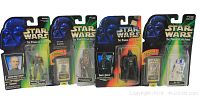 Front view of all four Star Wars 'Power of the Force' collectible figures in original packaging lined up side by side, showing front of cards and bubble displays.