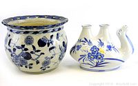 Two Chinese ceramic home decor pieces including a round pot and a bird-shaped double-spouted vessel in blue and white