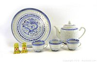 Wide shot of the entire tea set and salt & pepper shakers arranged front-facing in good lighting.