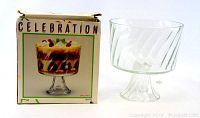 Photo showing the clear glass dessert dish with diagonal swirled glass design next to original box labeled 'Celebration'