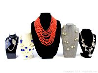 Front view of 5 vintage necklaces displayed on bust stands showing variety in styles and colors