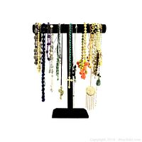 Front view of vintage mix of over 30 necklaces on black T-bar stand showing a variety of colors, beads, crosses, and pendants