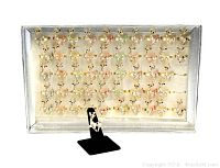Display box of 49 new reindeer fashion rings arranged in rows, gold-tone with colorful rhinestone accents.