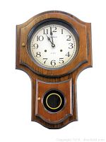 Front view of vintage Dimension wooden wall clock showing face and pendulum window.
