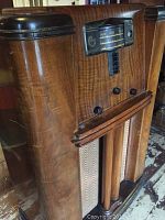 Front view of the Sparton radio showing the wooden cabinet, dial window with frequency display, and control knobs.